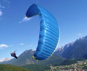 a person flying a blue kite in the air at Affittacamere Agli Ulivi in Gemona del Friuli