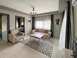 a living room with a couch and a table at Easy Stay Mia Suites in Aydın