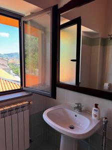 a bathroom with a sink and two windows at La terrazza del cilento in Perito