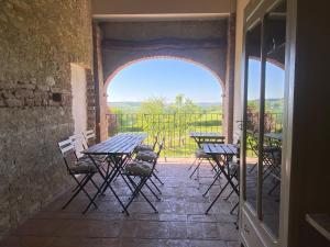 an outdoor patio with tables and chairs and a window at Tempo al Tempo in Villadeati