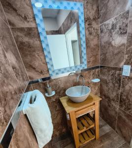 a bathroom with a bowl sink and a mirror at Depto Civora 4 in Villa Regina