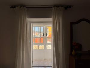 a door with a window and a mirror in a room at Casa do medio in Corcubión +16 photos