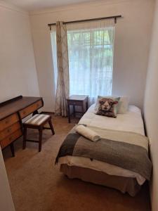 a bedroom with a bed with a teddy bear on it at Guesthouse at Lucia in Bethlehem