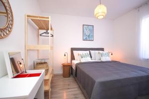 a bedroom with a large bed and a mirror at Apartments Katušić in Cavtat