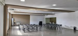 a room with a bunch of chairs in it at Hotel Mirage in Vilhena