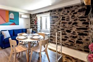 a dining room with a table and chairs at Social Lodge Galinho House - Sea View - Calheta in Estreito da Calheta