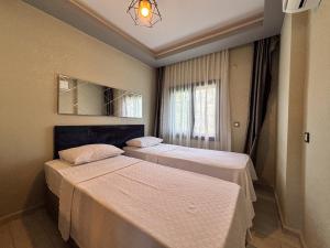 a bedroom with two beds and a window at Easy Stay Mia Suites in Aydın +25 photos