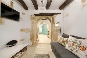 a living room with a couch and a tv at Villa Amanda by CVR in Roústika