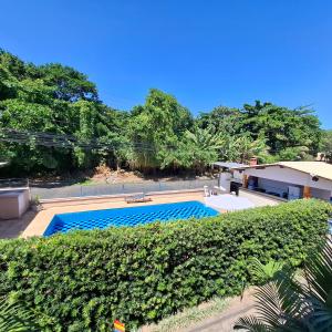a swimming pool in front of a house at Mestre Lord Apart Hotel 300m Praia Taperapuã by La Vem Férias in Porto Seguro