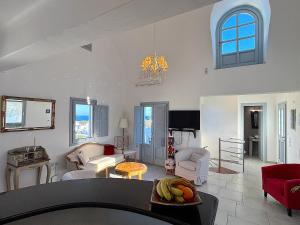 a living room with a couch and a table at Villa Galathea in Kamari