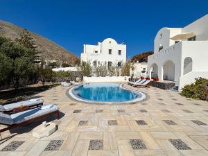 a patio with a swimming pool in front of a building at Villa Galathea in Kamari
