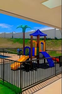 a playground in a building with a painting on the wall at Safiras Premium | Seu conforto em Cuiabá in Cuiabá
