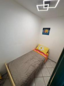 a small bed in a corner of a room at Casa Ady in San Teodoro