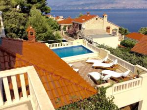 an aerial view of a house with a swimming pool at House Postira Horizon in Postira +20 photos