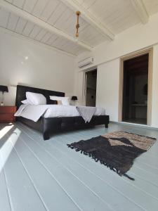 a bedroom with a bed and a rug on the floor at Sunrise House in Kefalos