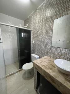 a bathroom with a toilet and a sink and a shower at Casa aconchegante em Bezerros- REI DAVID CONDOMÍNIO CLUBE in Bezerros +21 photos