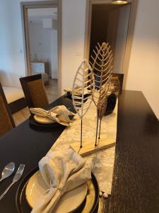 a table with plates and utensils on top at Sunrise House in Kefalos +19 photos