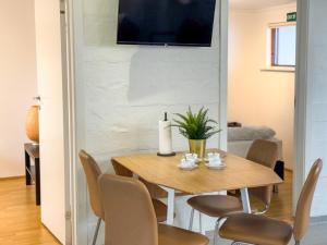 a dining room with a wooden table and chairs at Fagrahlid Guesthouse in Hvolsvöllur