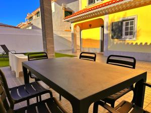 a wooden table and chairs on a patio at Sítio D'Elvas in Elvas