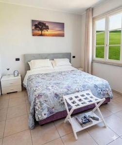 a bedroom with a bed and a table in it at Villa Leilani B&B in Sale Marasino