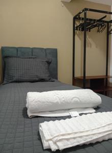 a bedroom with a bed with white towels on it at Pousada e hostel Italia in São Luís