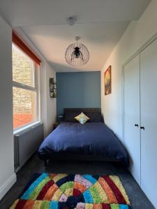 a bedroom with a bed with a colorful rug at Full Apartment in the Heart of Margate in Margate