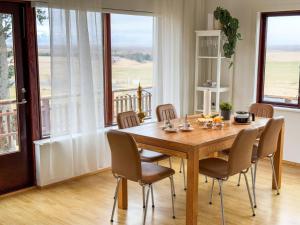 a dining room with a wooden table and chairs at Fagrahlid Guesthouse in Hvolsvöllur
