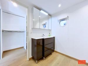 a bathroom with a sink and a refrigerator at L'ancrage in Wimereux +28 photos