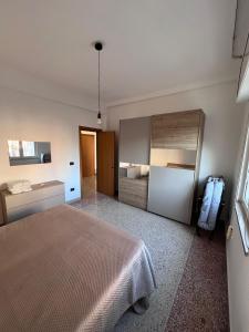 a bedroom with a bed and a large cabinet at HAKUNA MATATA Elegant Apartment in Central Taranto in Taranto
