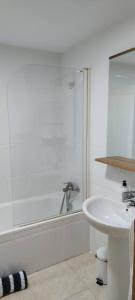 a white bathroom with a sink and a shower at Aprt ESTUDIO ARRIXACA in Murcia +7 photos