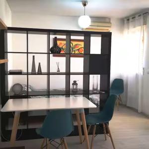 a dining room with a table and two chairs at Aprt ESTUDIO ARRIXACA in Murcia