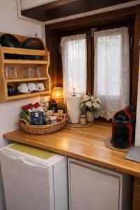 a kitchen with a counter with a refrigerator and a window at MonemBlue in Monemvasia