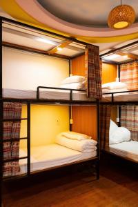 a room with three bunk beds in a room at Su Ha Giang Hostel in Ha Giang