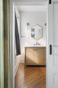 a bathroom with a sink and a mirror at 4th Floor Queen Suite Boutique hotel in Savannah +12 photos