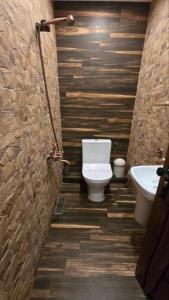 a bathroom with a toilet and a sink at Къща за гости Велчева Завера in Samokov