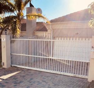 a white fence in front of a house at Bonne Esperance in Tyger Valley