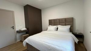 a bedroom with a large bed with white sheets at Luxury Villa Grey in Široki Brijeg +29 photos