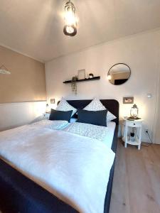 a bedroom with a large bed with blue pillows at Ferienwohnungen Naheliebe in Bärenbach