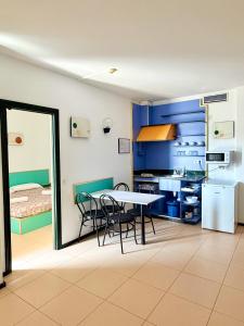 a kitchen with a table and chairs in a room at Apartments Lloret Sun in Lloret de Mar