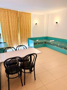 a room with a table and chairs and a aquarium at Apartments Lloret Sun in Lloret de Mar