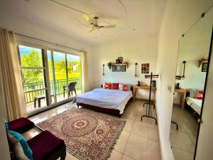 a bedroom with a bed and a balcony at Social Monkey Hostel Bir in Bīr +126 photos