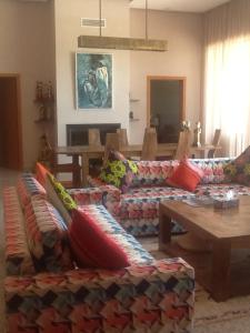 a living room with a couch and a table at DOMAINE VILLa in Tameslouht