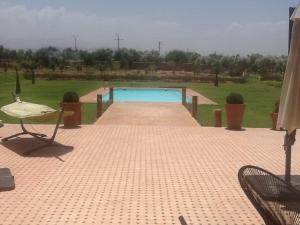 a swimming pool in the middle of a yard at DOMAINE VILLa in Tameslouht