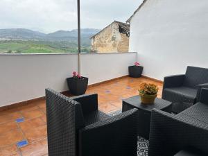 a balcony with chairs and a table with a view at Exclusive Views Ronda in Ronda
