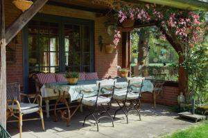 a patio with a table and chairs on a house at De Fazant in Laren