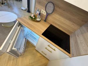 a kitchen with a counter top with a microwave at Baltic Avenue in Klaipėda +54 photos