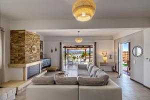 a living room with a couch and a fireplace at Villa Angelo Porto Heli - Private Pool in Porto Heli