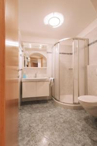 a bathroom with a shower and a sink and a toilet at Residence Fallrohrhof in Naturno +42 photos