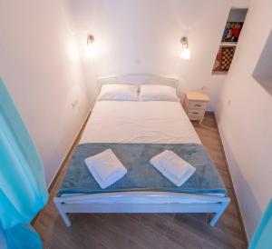 a bedroom with a bed with two towels on it at Alexandra House in Kimolos