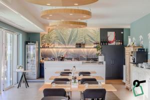 a restaurant with tables and chairs and a bar at Hotiday Lazise Garda in Lazise